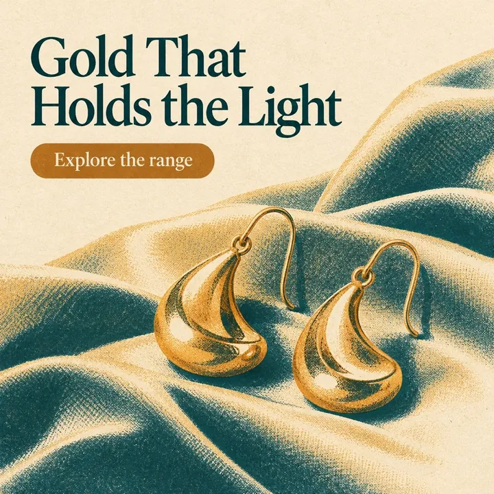 A sample jewellery post, "Gold That Holds the Light": a pair of gold teardrop earrings resting on teal fabric